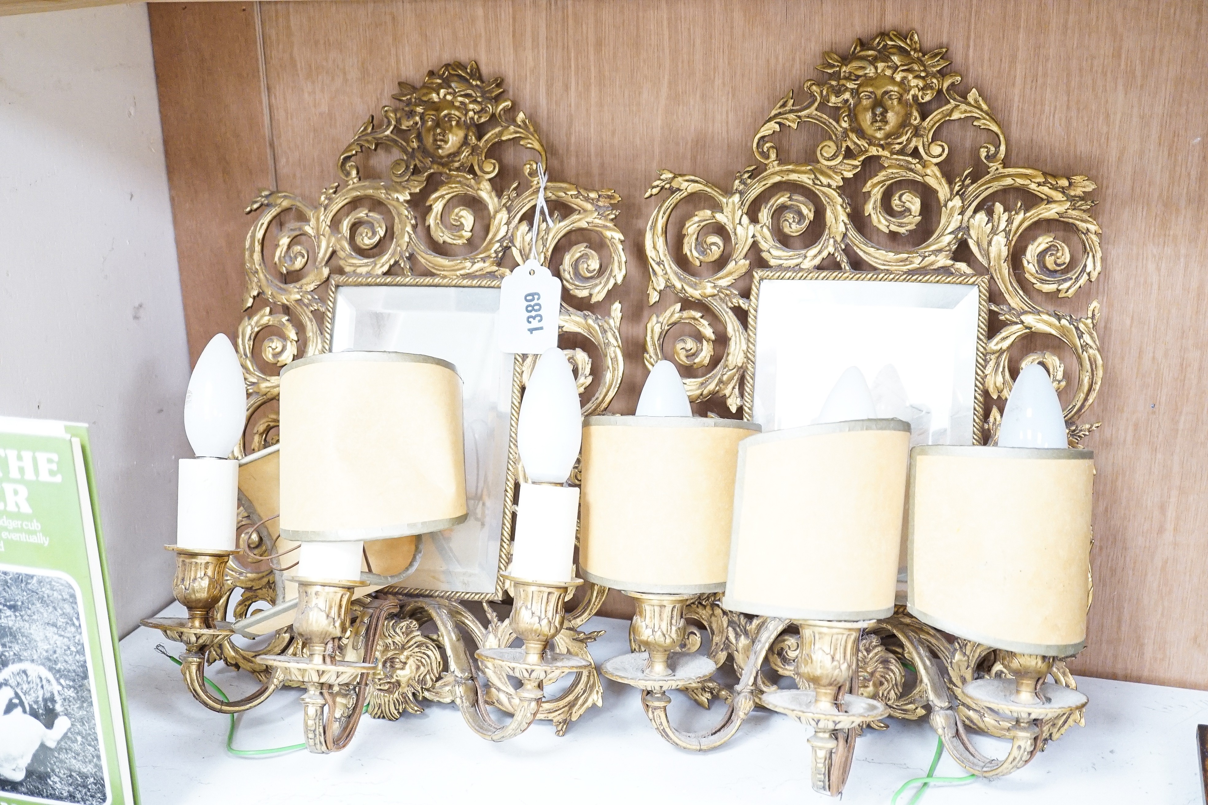 A pair of early 20th century gilt brass girandole mirrors, 39cms high.